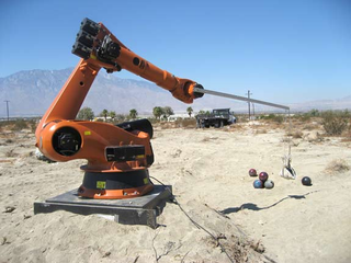 Illustration for article titled $70,000 Industrial Robot Modded to Fire Flameballs